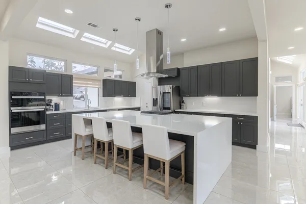 a kitchen with kitchen island granite countertop a sink and counter space