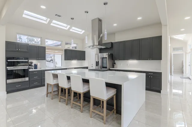 a kitchen with kitchen island granite countertop a sink and counter space