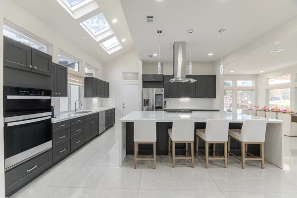 a large kitchen with a table and chairs