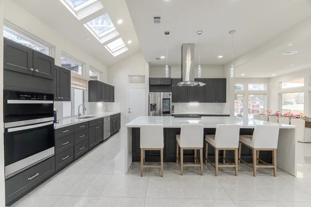 a large kitchen with a table and chairs
