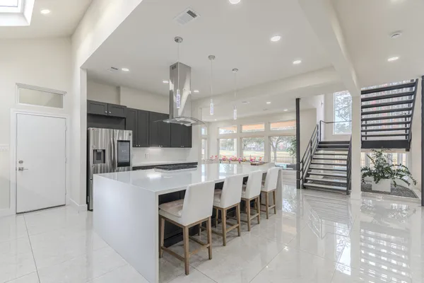 a large kitchen with a table and chairs