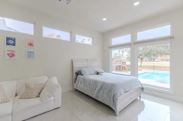 a bedroom with a large bed and a couch