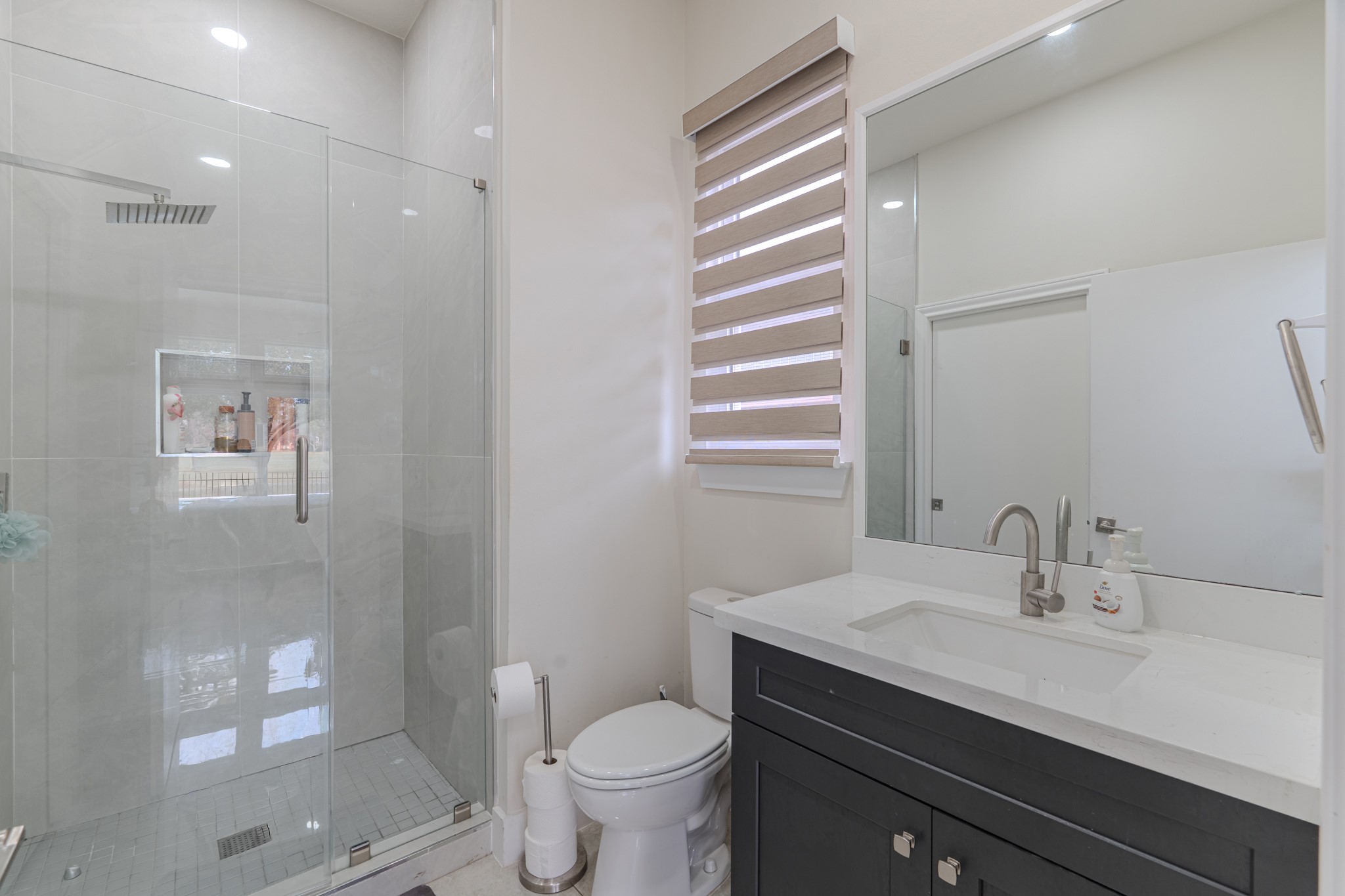 6510 Sussex Court Spring, TX 77389 - Photo 27 of 47 a bathroom with a sink a toilet a mirror and shower