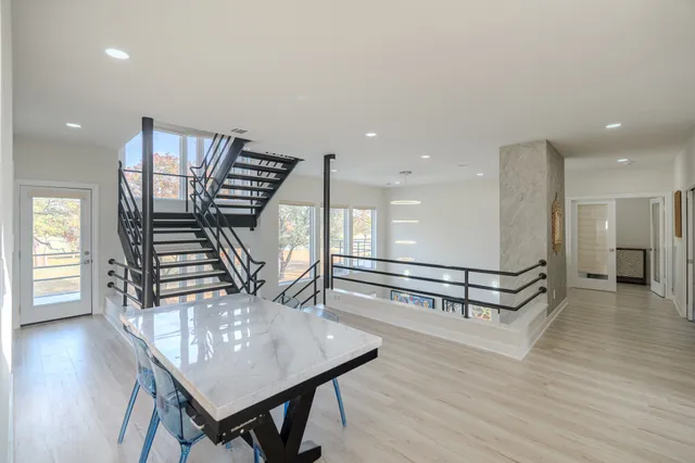 a view of a room with furniture and wooden floor