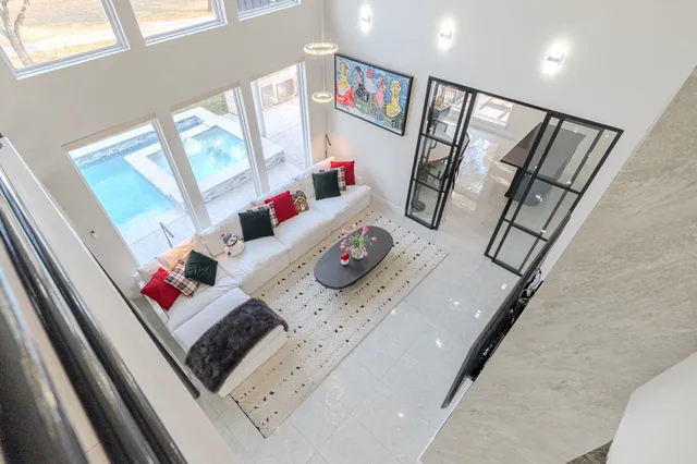 a living room with furniture and a potted plant