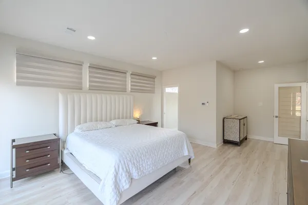 a spacious bedroom with a bed and a couch