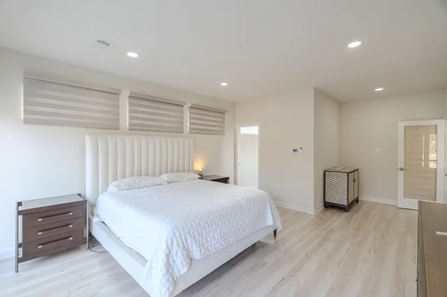 a spacious bedroom with a bed and a couch