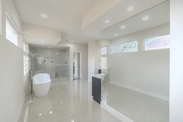 a bathroom with a granite countertop sink a toilet and shower