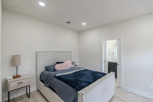 a bedroom with a bed and a mirror