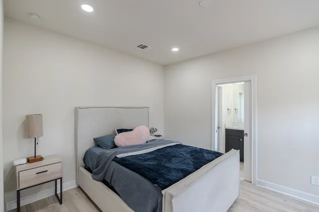 a bedroom with a bed and a mirror