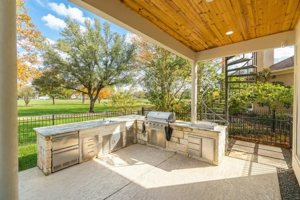 a view of a patio with couches and table and chairs and floor to ceiling window