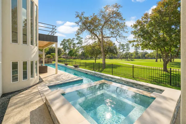 a view of a swimming pool with a patio