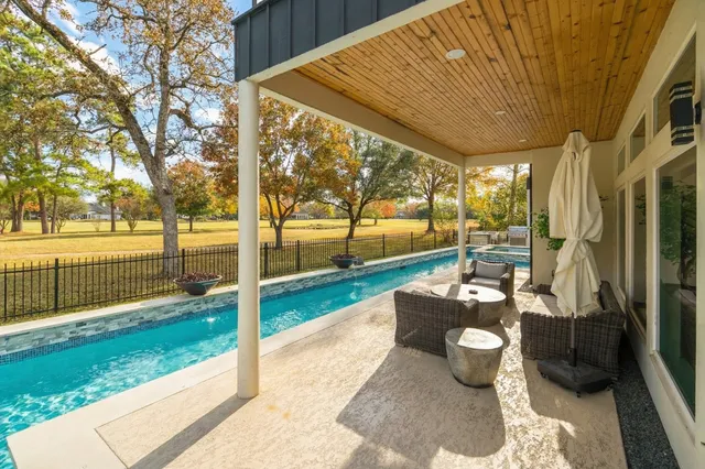 a patio with table and chairs and garden