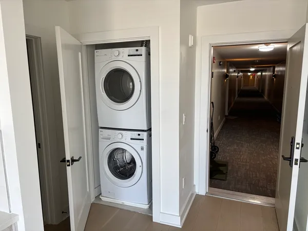 a view of a hallway with washer and dryer