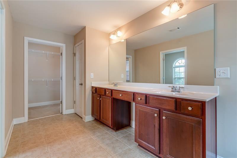 3590 Falling Leaf Lane Cumming, GA 30041 - Photo 28 of 37 a spacious bathroom with a granite countertop double vanity and a mirror