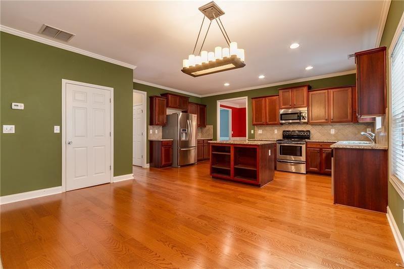 3590 Falling Leaf Lane Cumming, GA 30041 - Photo 10 of 37 a kitchen with stainless steel appliances granite countertop a refrigerator and stove top oven