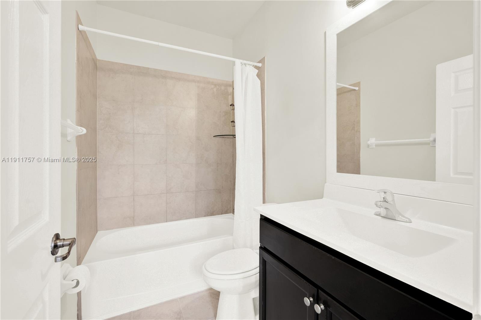 11411 Southwest 248th Lane Homestead, FL 33032 - Photo 24 of 40 a bathroom with a sink a toilet a mirror and shower