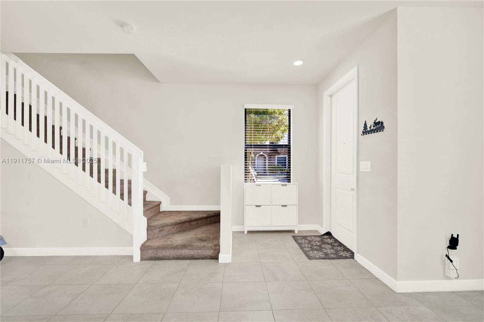 11411 Southwest 248th Lane Homestead, FL 33032 - Photo 4 of 40 a view of entryway with stairs and a living room