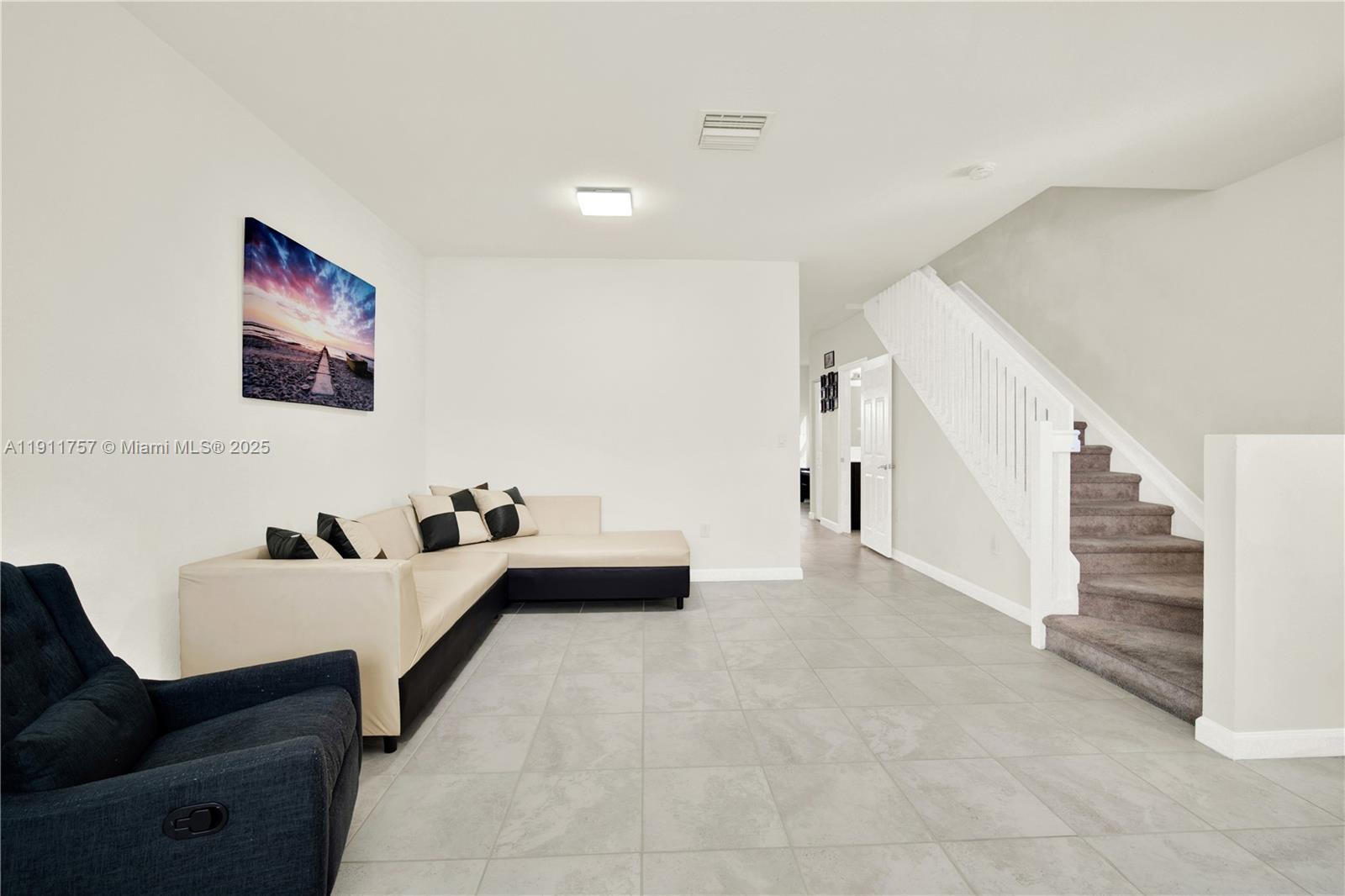 11411 Southwest 248th Lane Homestead, FL 33032 - Photo 5 of 40 a living room with furniture and stairs
