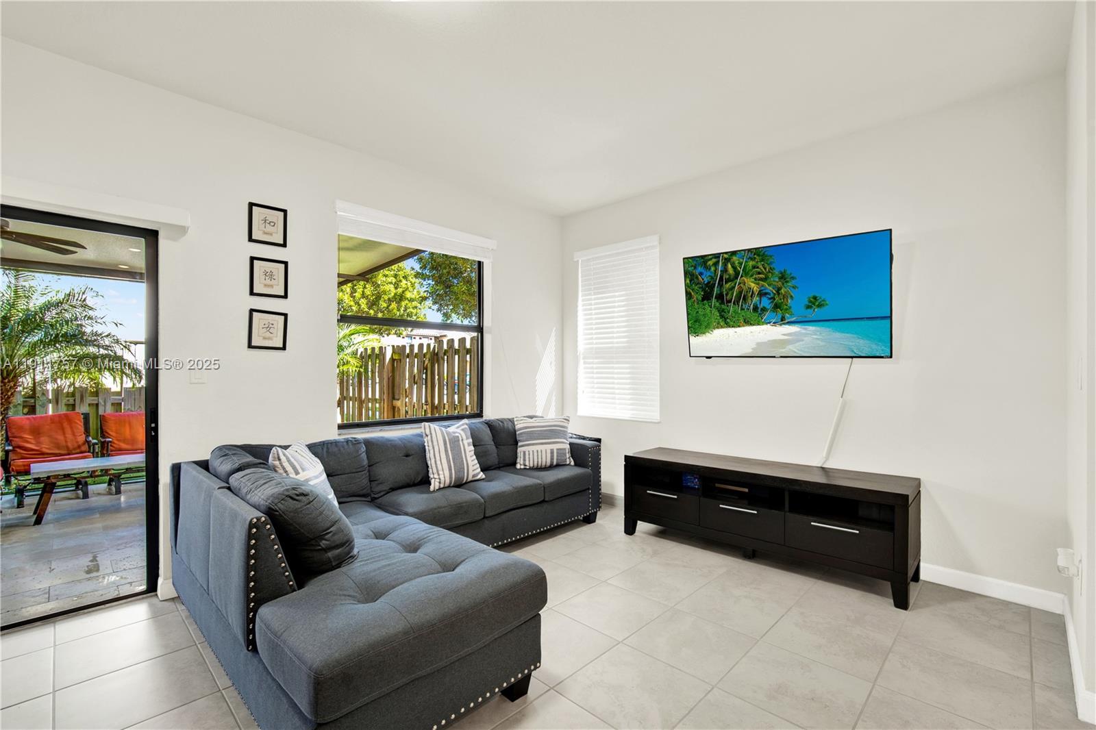 11411 Southwest 248th Lane Homestead, FL 33032 - Photo 9 of 40 a living room with furniture and a flat screen tv