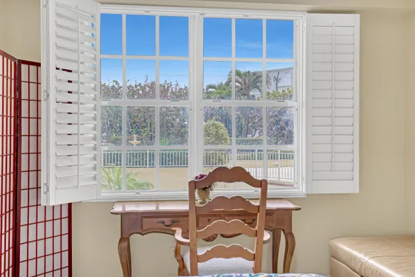 a room with a chair and a window