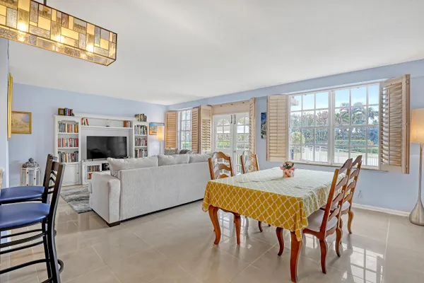 a living room with furniture a flat screen tv and a table