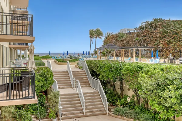 a balcony with outdoor seating and plants