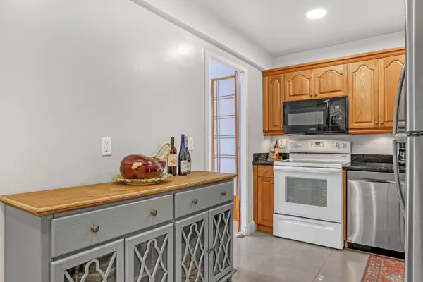 a kitchen with stainless steel appliances a stove microwave and refrigerator