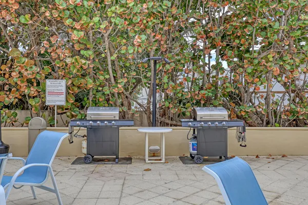 a view of a chairs and table in a backyard