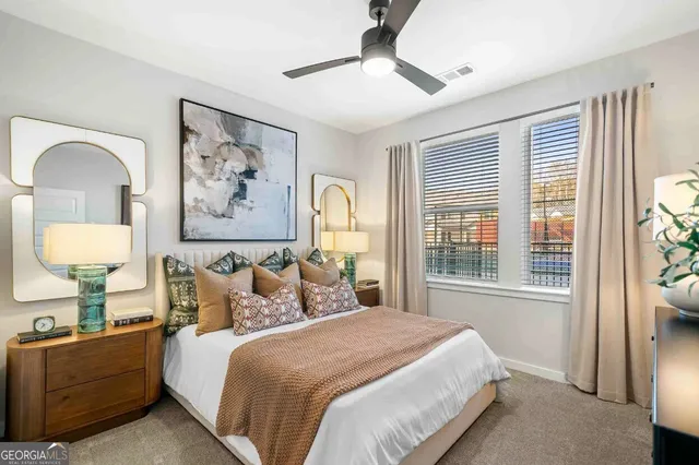 a bedroom with a bed and a painting on the wall