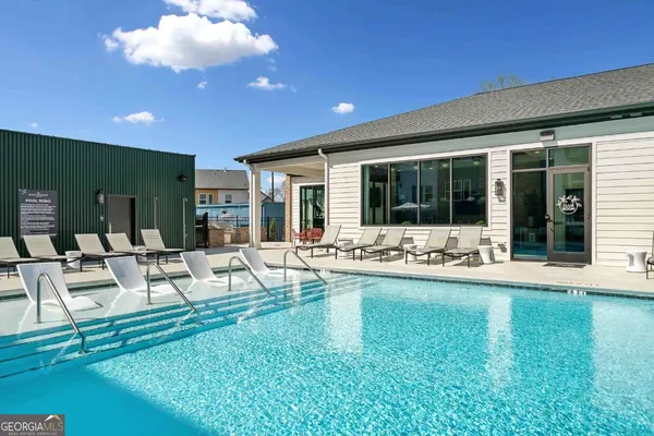a view of swimming pool with seating area and furniture