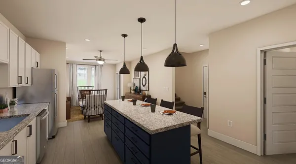 a kitchen with a sink a counter space appliances and cabinets