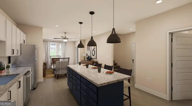 a kitchen with a sink a counter space appliances and cabinets