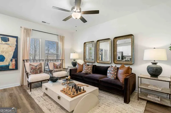 a living room with furniture a rug and a chandelier