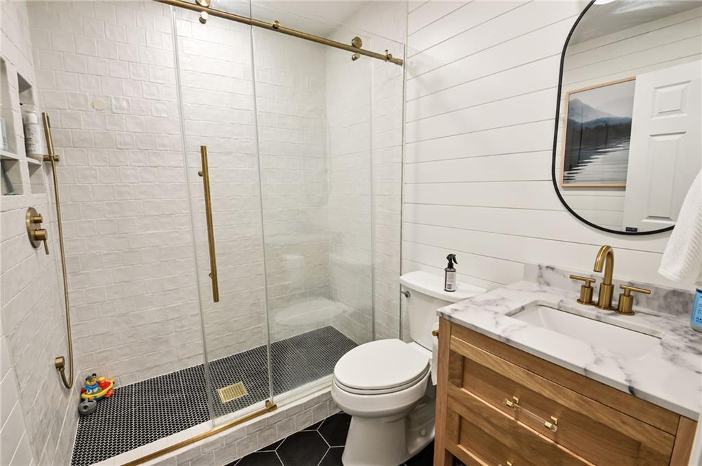 150 Sims Street Winder, GA 30680 - Photo 34 of 61 a bathroom with a sink a toilet and shower