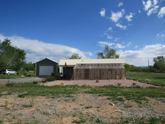 a view of a house with a yard and pathway