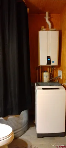 a living room with a couch and a potted plant