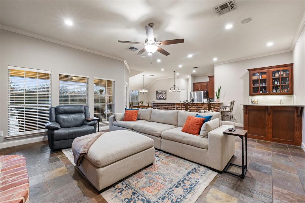 517 Chado Lane Robinson, TX 76706 - Photo 4 of 40 Living room featuring crown molding, a ceiling fan, stone tile floors, and recessed lighting