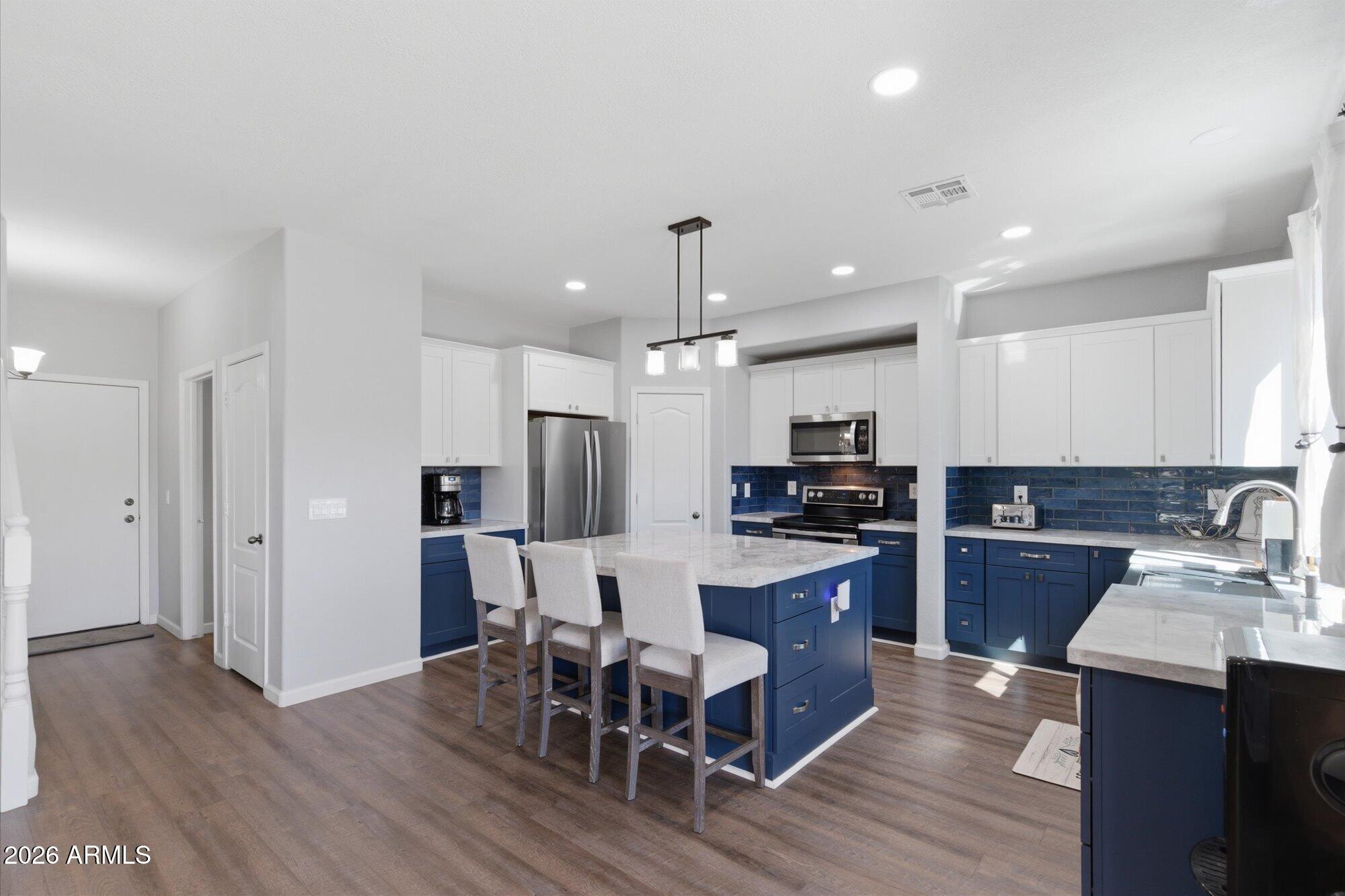 21915 Dietz Drive Maricopa, AZ 85138 - Photo 4 of 31 a kitchen with refrigerator and wooden floor