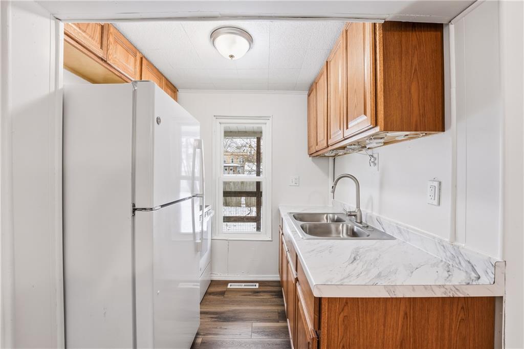 315 Mitchell Avenue Butler, PA 16001 - Photo 7 of 19 a kitchen with stainless steel appliances granite countertop a sink and a refrigerator