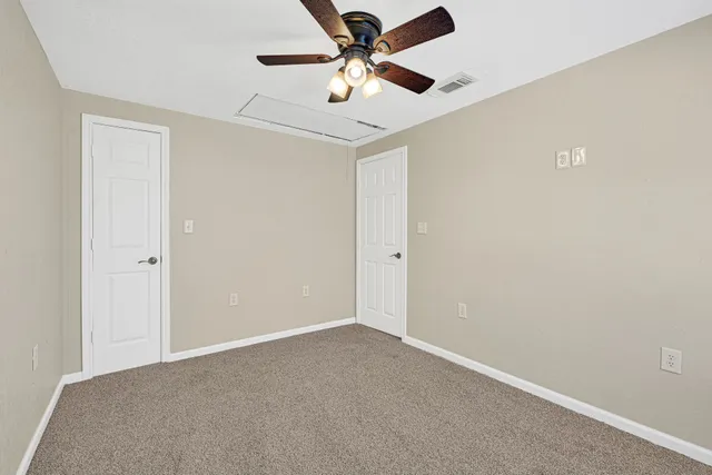 a view of a room with a ceiling fan