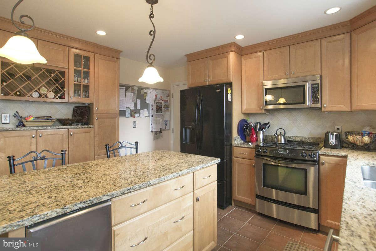 21107 Gunpowder Road Manchester, MD 21102 - Photo 2 of 30 a kitchen with stainless steel appliances granite countertop a stove refrigerator and microwave