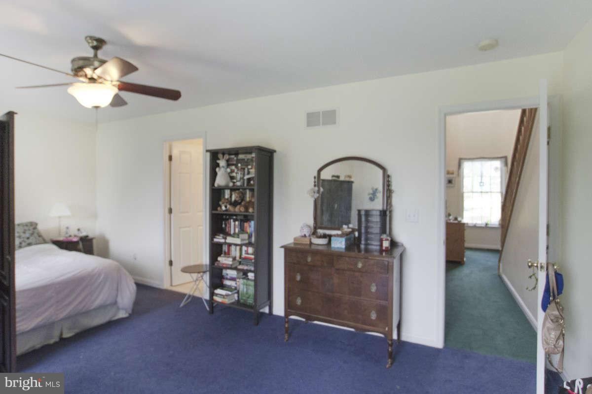 21107 Gunpowder Road Manchester, MD 21102 - Photo 17 of 30 a bedroom with a bed and a chandelier