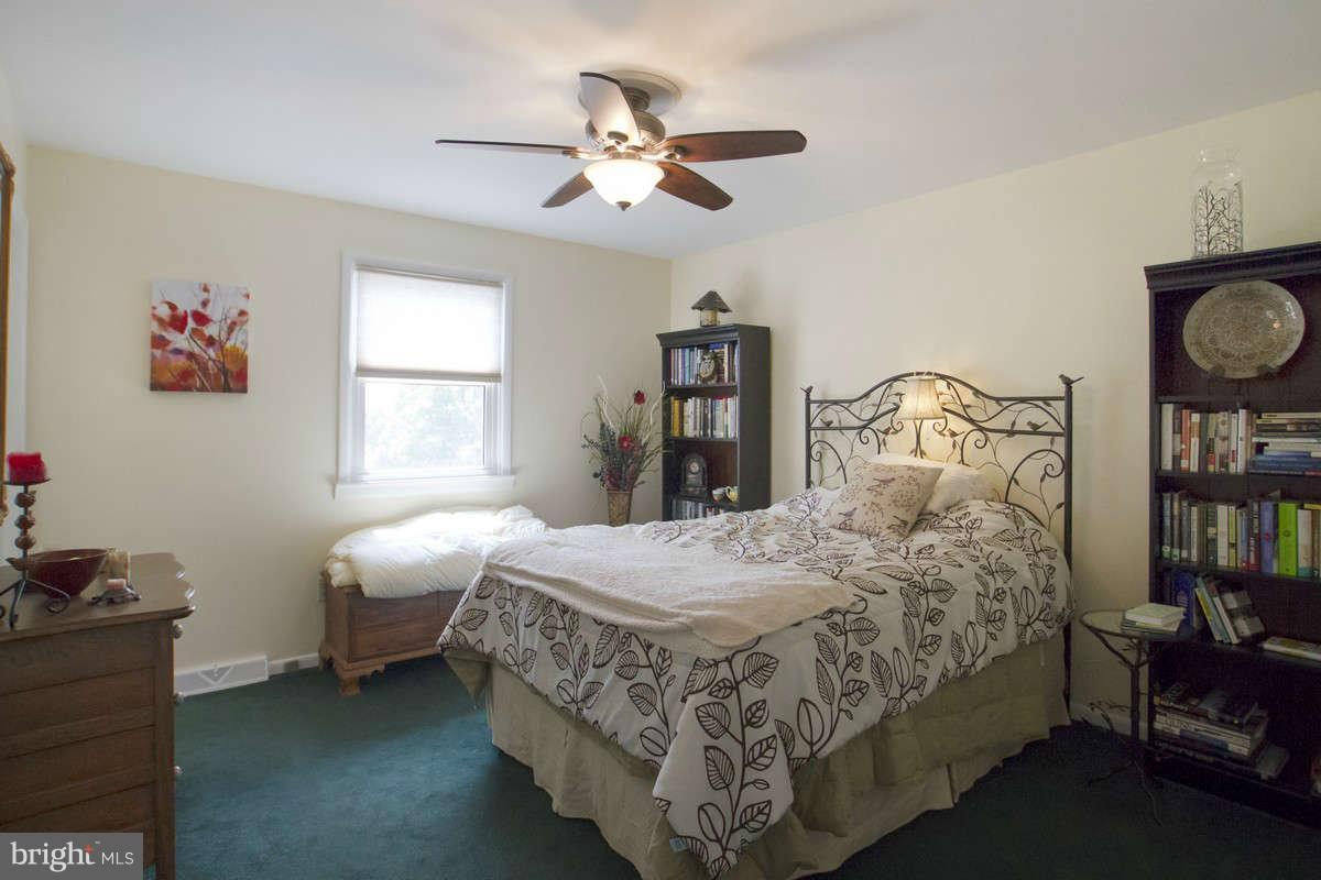 21107 Gunpowder Road Manchester, MD 21102 - Photo 23 of 30 a bedroom with a bed a window and a chandelier