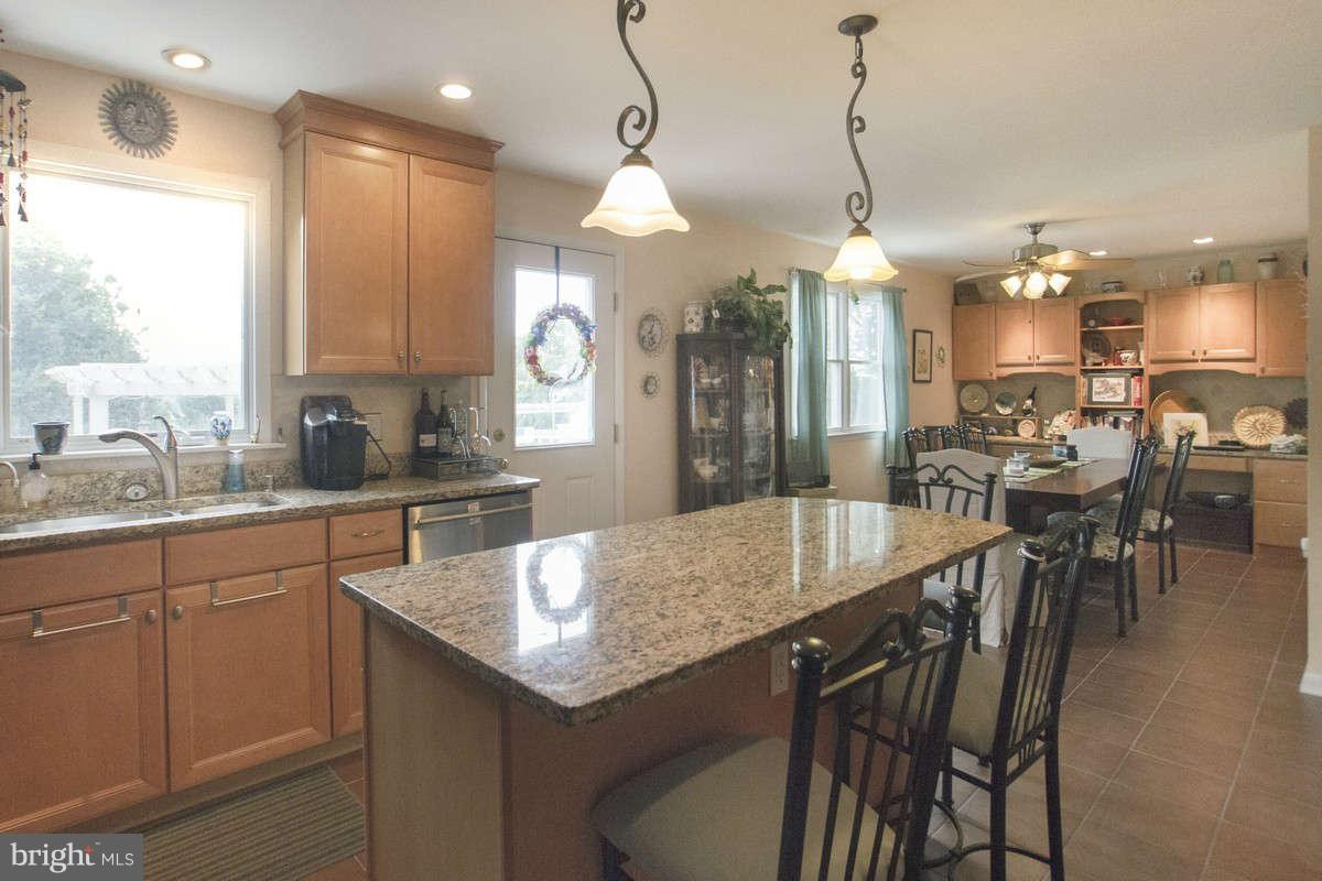 21107 Gunpowder Road Manchester, MD 21102 - Photo 9 of 30 a kitchen with granite countertop a table chairs sink and cabinets