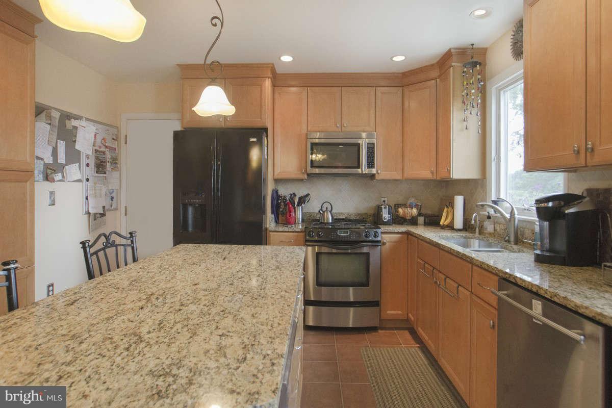 21107 Gunpowder Road Manchester, MD 21102 - Photo 10 of 30 a kitchen with stainless steel appliances granite countertop a sink refrigerator and microwave