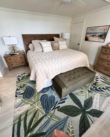 a large white kitchen with a refrigerator a sink stainless steel appliances and cabinets