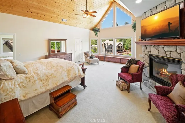 a living room with fireplace furniture and a wooden floor