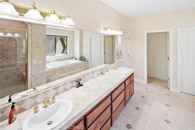 a bathroom with a sink vanity granite shower and a mirror