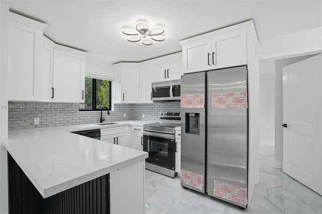 a kitchen with a sink stainless steel appliances and cabinets